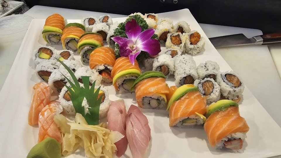 Korean restaurant dishes with sashimi and sushi.